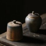 antique japanese ceramic tea canister with rustic metallic glaze