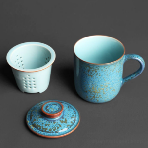 full view of blue speckled ceramic loose leaf tea infuser mug with lid