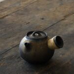 full side view handcrafted gilded ceramic kyusu teapot with hemp wrapped handle