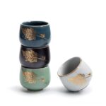 hand-decorated japanese tea cup with gold leaf and insect motif side view