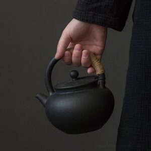 handcrafted black volcanic clay japanese teapot with hemp wrapped handle