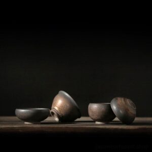 collection of handcrafted gilded japanese tea bowls on wooden tea tray