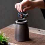 Handcrafted Japanese airtight ceramic tea canister with navy floral cloth lid