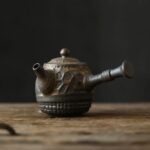 full side view of handcrafted dark brown japanese kyusu teapot with strainer
