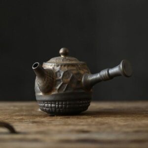 full side view of handcrafted dark brown japanese kyusu teapot with strainer