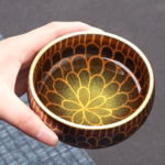 side view of handcrafted 5.7oz japanese tea bowl with golden petal pattern
