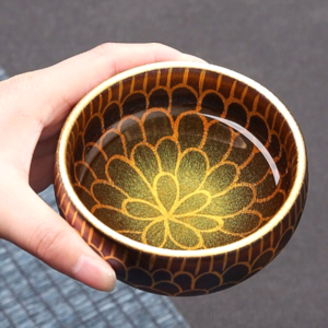 side view of handcrafted 5.7oz japanese tea bowl with golden petal pattern