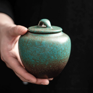 handheld handcrafted japanese tea canister with rustic teal brown gradient