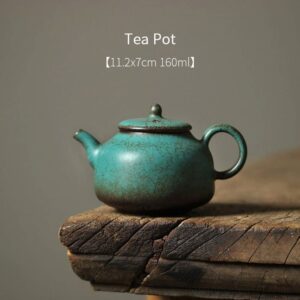full view of handcrafted mottled turquoise japanese ceramic teapot