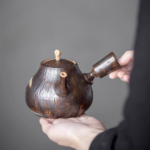 front view of handcrafted wood grain ceramic kyusu teapot side handle