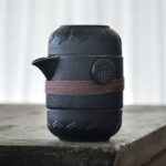 japanese style black ceramic portable travel tea set with carved lotus and fuku design