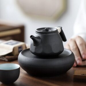 handmade japanese black clay teapot with matching teacups display