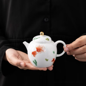 hand held japanese ceramic fish teapot side view
