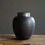 full product view of textured black japanese ceramic tea canister with airtight metal lid