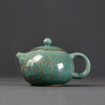 full side view of japanese handcrafted ceramic teapot green with gold speckles