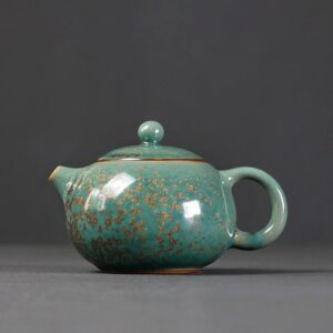 full side view of japanese handcrafted ceramic teapot green with gold speckles