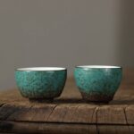 handcrafted japanese green porcelain tea cup with natural brown crackle glaze
