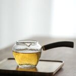 Japanese hammered glass fairness cup with dark wood handle main view