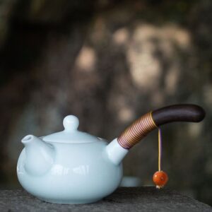 Handcrafted Japanese Kyusu teapot with light blue ceramic body and wooden side handle