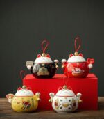 full shot of yellow japanese maneki-neko fortune cat ceramic tea canister