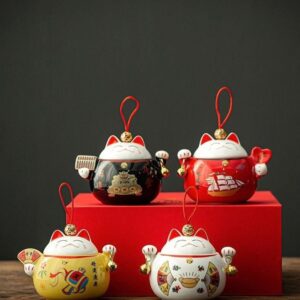 full shot of yellow japanese maneki-neko fortune cat ceramic tea canister
