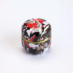 traditional japanese style matcha canister with crane cherry blossom motifs