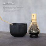 complete traditional japanese matcha set with black chawan, bamboo chasen, chashaku and naoshi holder