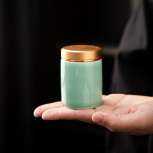 compact japanese matcha powder canister green ceramic with gold lid side view