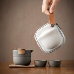full view of compact dark grey japanese ceramic travel tea set with wood handle