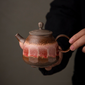 full view of japanese vintage handcrafted clay teapot with red brown kiln glaze