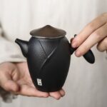 full view of japanese wandering hero black ceramic teapot 7.8oz