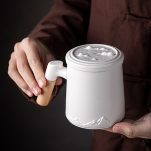 loose leaf tea infuser mug with mountain relief ceramic body and wooden handle