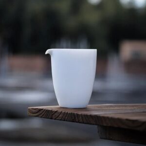 6.7oz minimalist white porcelain Japanese fairness cup gong dao bei on wooden table