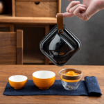 full set of orange shaped japanese portable travel tea set in black carry bag
