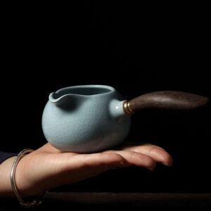 side view sky blue ru kiln porcelain fairness cup with wood handle