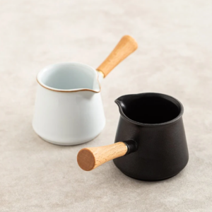 white black ceramic fairness cup gong dao bei with wooden handle side view